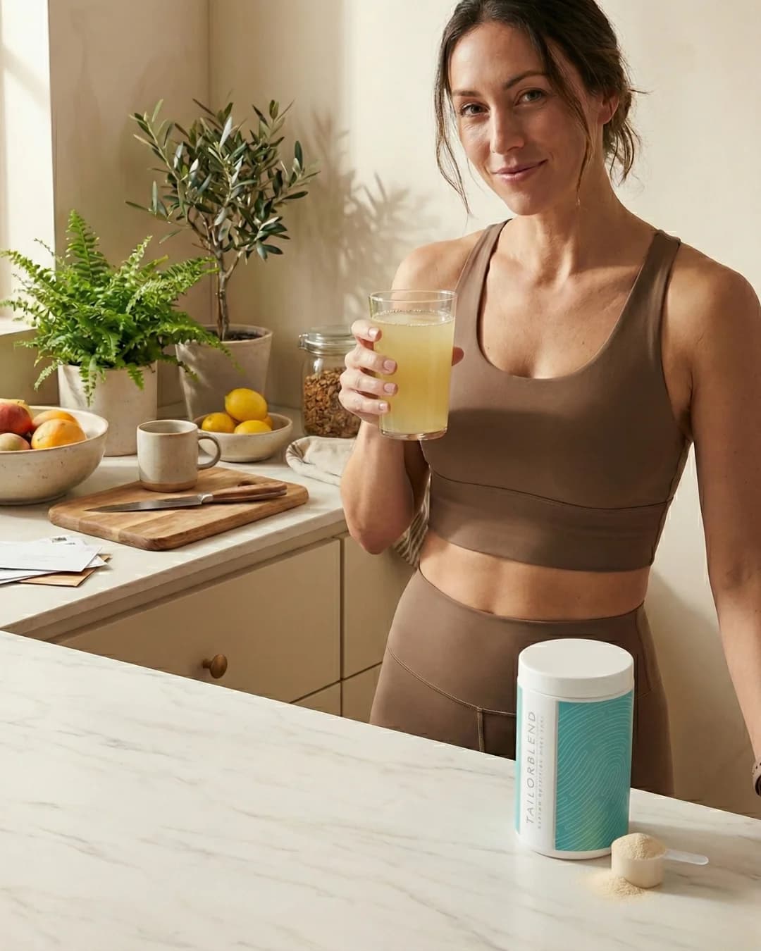 Woman enjoying TAILORBLEND drink in kitchen
